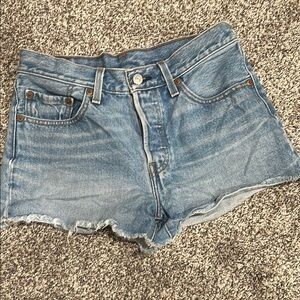 Levi’s 501 Blue Jean Shorts with Distressed Hem and Form-Fitting Style